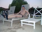 Relaxing in a deck chair at the pool after a long swim