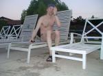 Chest hair, sitting in a deck chair at the pool