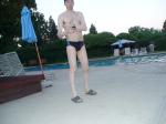 Nike black/blue swim brief, checking his cell phone