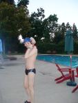 Nike black/blue speedo, adjusting his swim cap