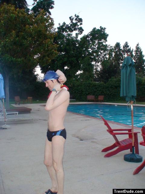 Nike black/blue speedo, adjusting his swim cap