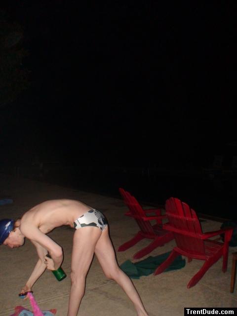 Grabbing some leis in a white polka dot speedo