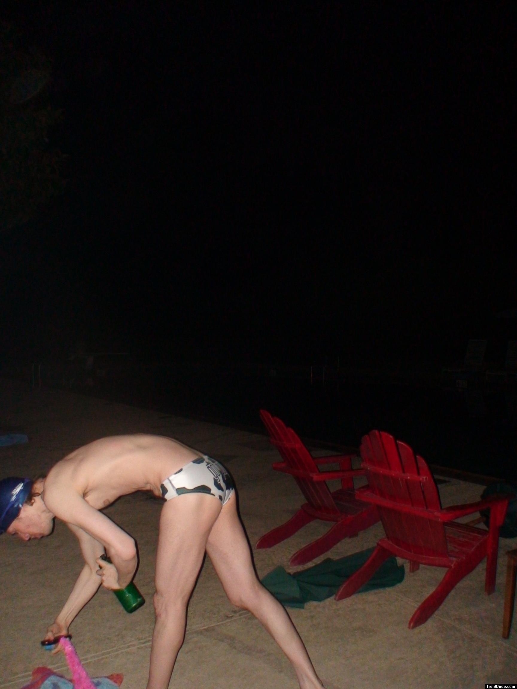 Grabbing some leis in a white polka dot speedo