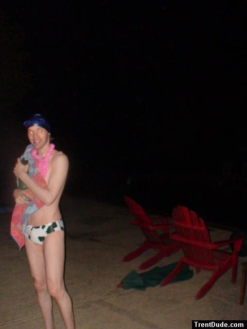 Holding a towel in a white/green cow print water polo swim brief