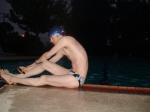 Stretching pool slide in a polka dot speedo