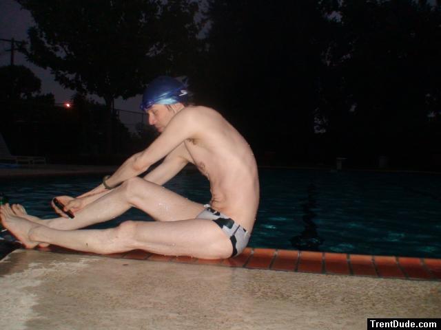 Stretching pool slide in a polka dot speedo
