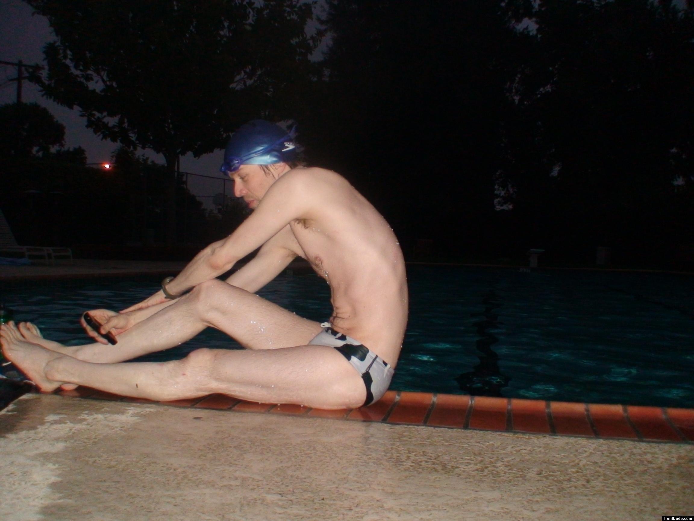 Stretching pool slide in a polka dot speedo