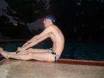 Stretching pool-side in a cow spot speedo