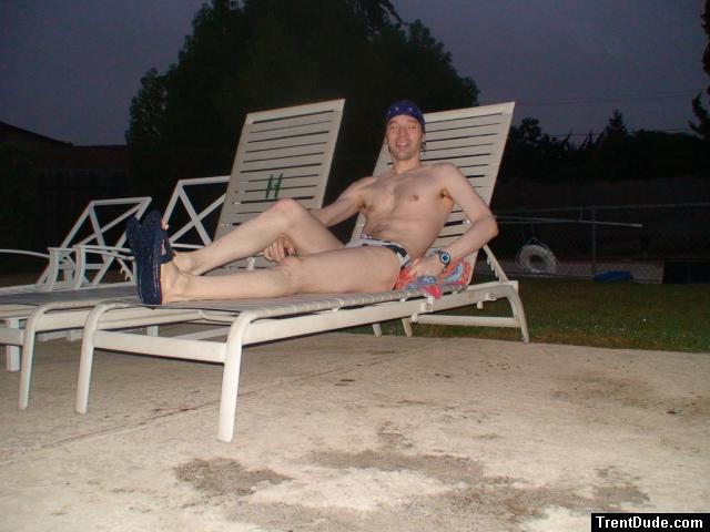 Sitting in a lounge chair in a polka dot speedo