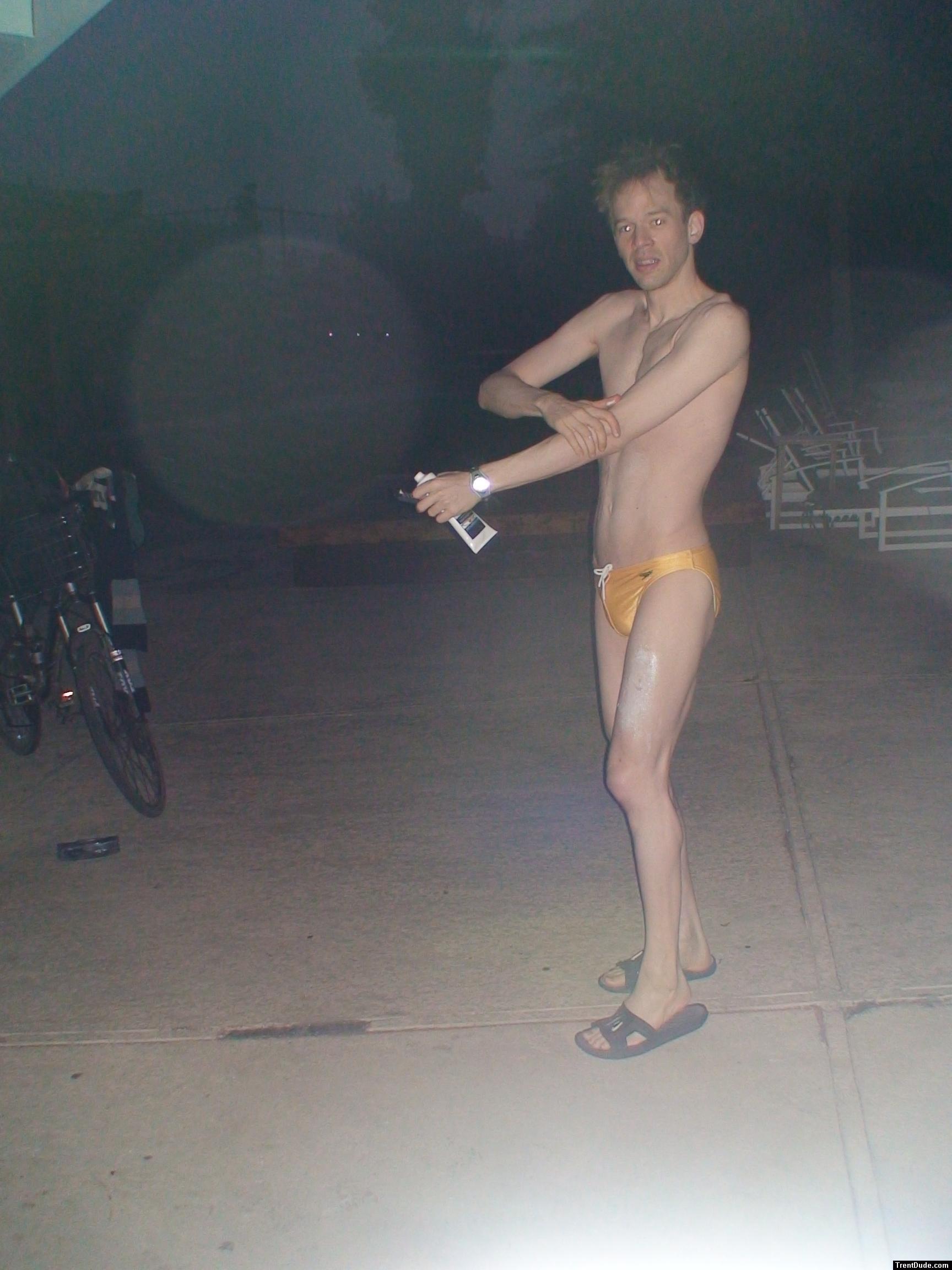 Putting anti-chlorine lotion on before a swim (yellow speedo)