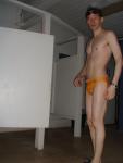 in the locker room in a yellow speedo