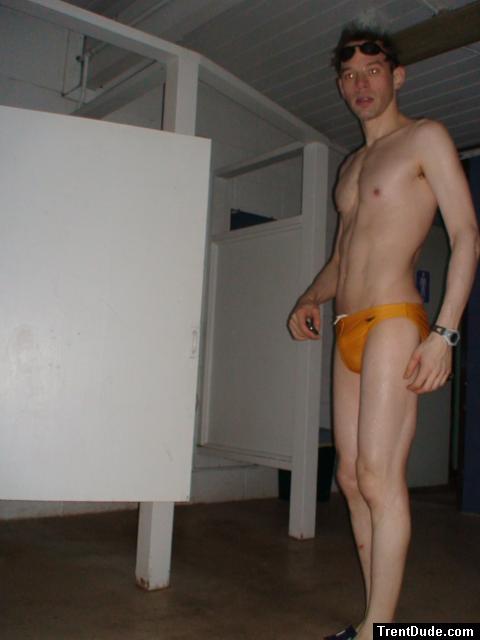 in the locker room in a yellow speedo