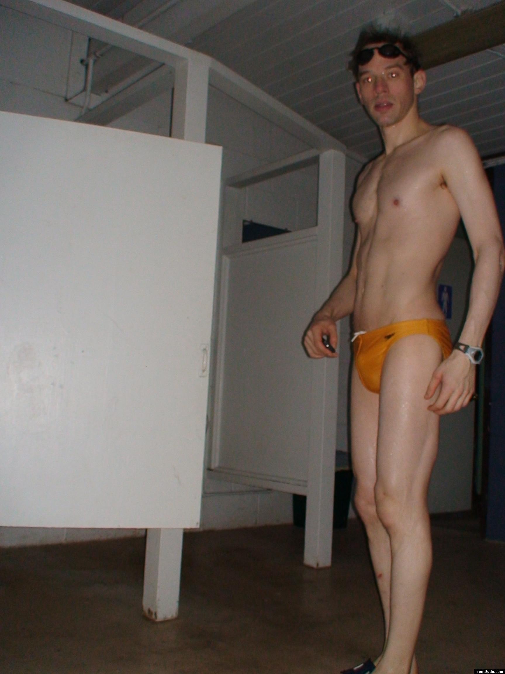 in the locker room in a yellow speedo