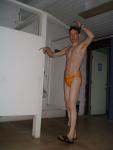 Stretching in the locker room in a yellow speedo (armpits)