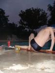 Swim team speedo size 30, relaxing next to the pool (rear)
