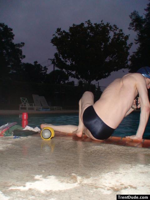 Swim team speedo size 30, relaxing next to the pool (rear)