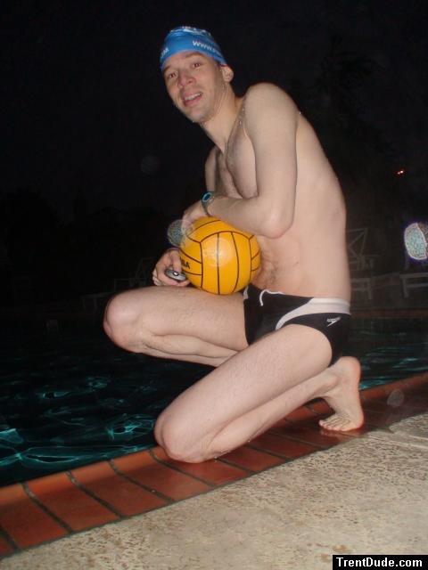 Swimmer in a speedo holding a water polo ball (feet)