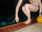 Veins in his arm, feet closeup - balancing on a water polo ball