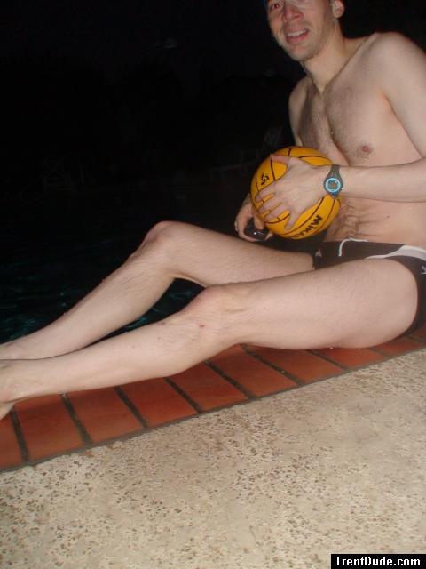 Swimmer in a speedo holding a water polo ball (feet)