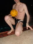 Swimmer in a speedo holding a water polo ball (feet)