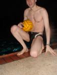 Swimmer in a speedo holding a water polo ball (feet) (chest hair)