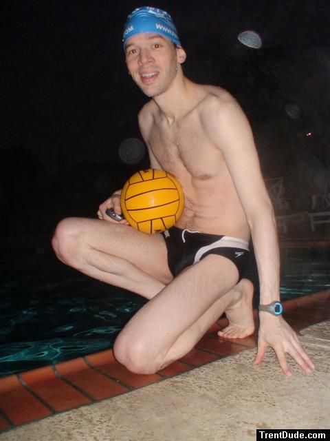 Swimmer in a speedo holding a water polo ball (feet)