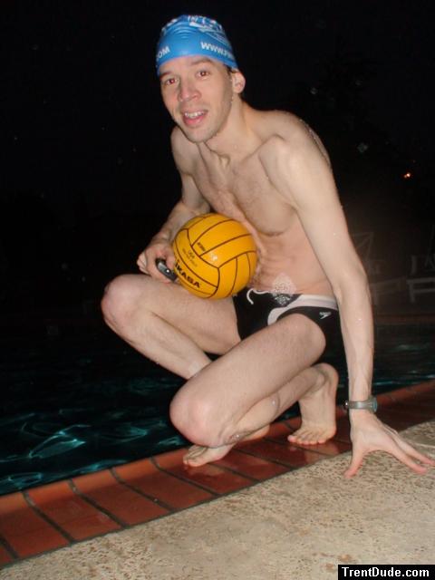 Swimmer in a speedo holding a water polo ball (feet)