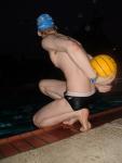 Holding the ball next to his back (feet)