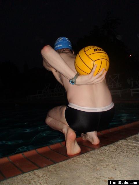 Holding the ball next to his back (feet)