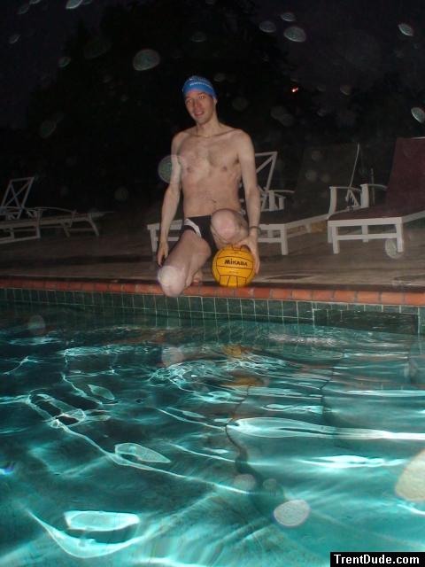 Sitting next to the pool, leg resting on ball