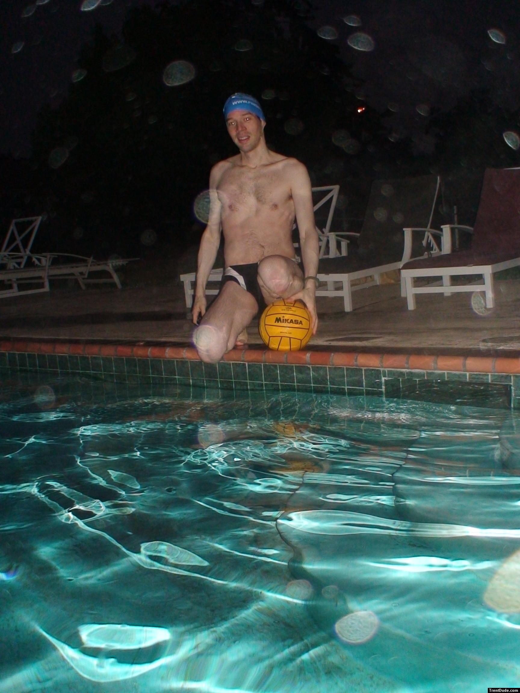 Sitting next to the pool, leg resting on ball