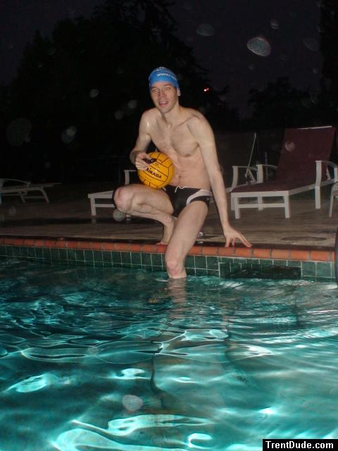Swimmer in speedo, swim cap, with water polo ball