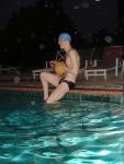 Swimmer in speedo, swim cap, with water polo ball