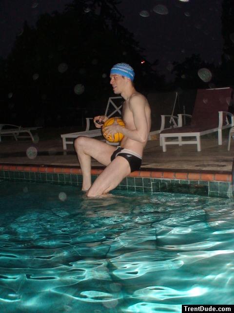 Swimmer in speedo, swim cap, with water polo ball