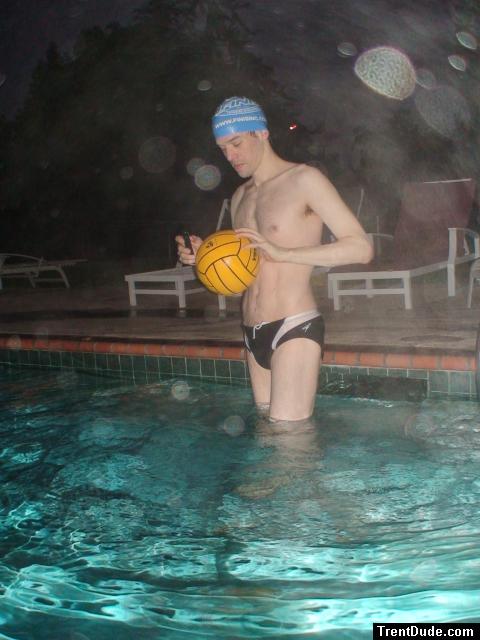 Inspecting the Water polo ball in a speedo (best).  The cap is labled www.finisinc.com