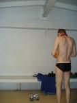 Inspecting the ball after a game in the locker room (rear)