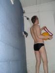 Holding the water polo ball in the shower (rear)