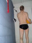 Holding the water polo ball in the shower (rear)