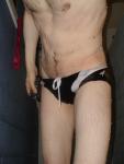 Closeup of black speedo, chest hair