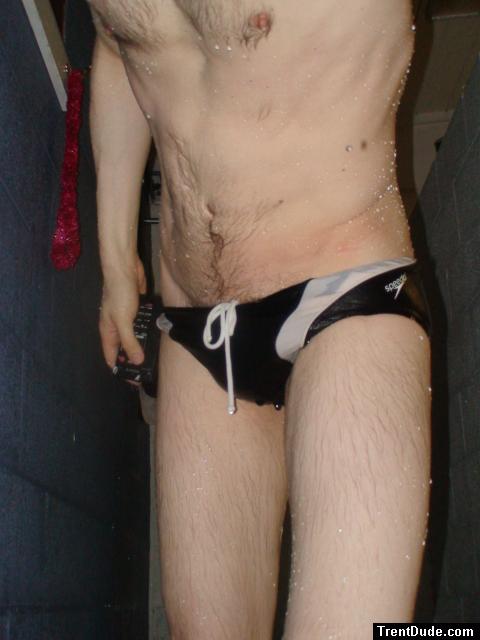 Closeup of black speedo, chest hair