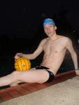Water polo player in a speedo, blue finisinc.com swim cap