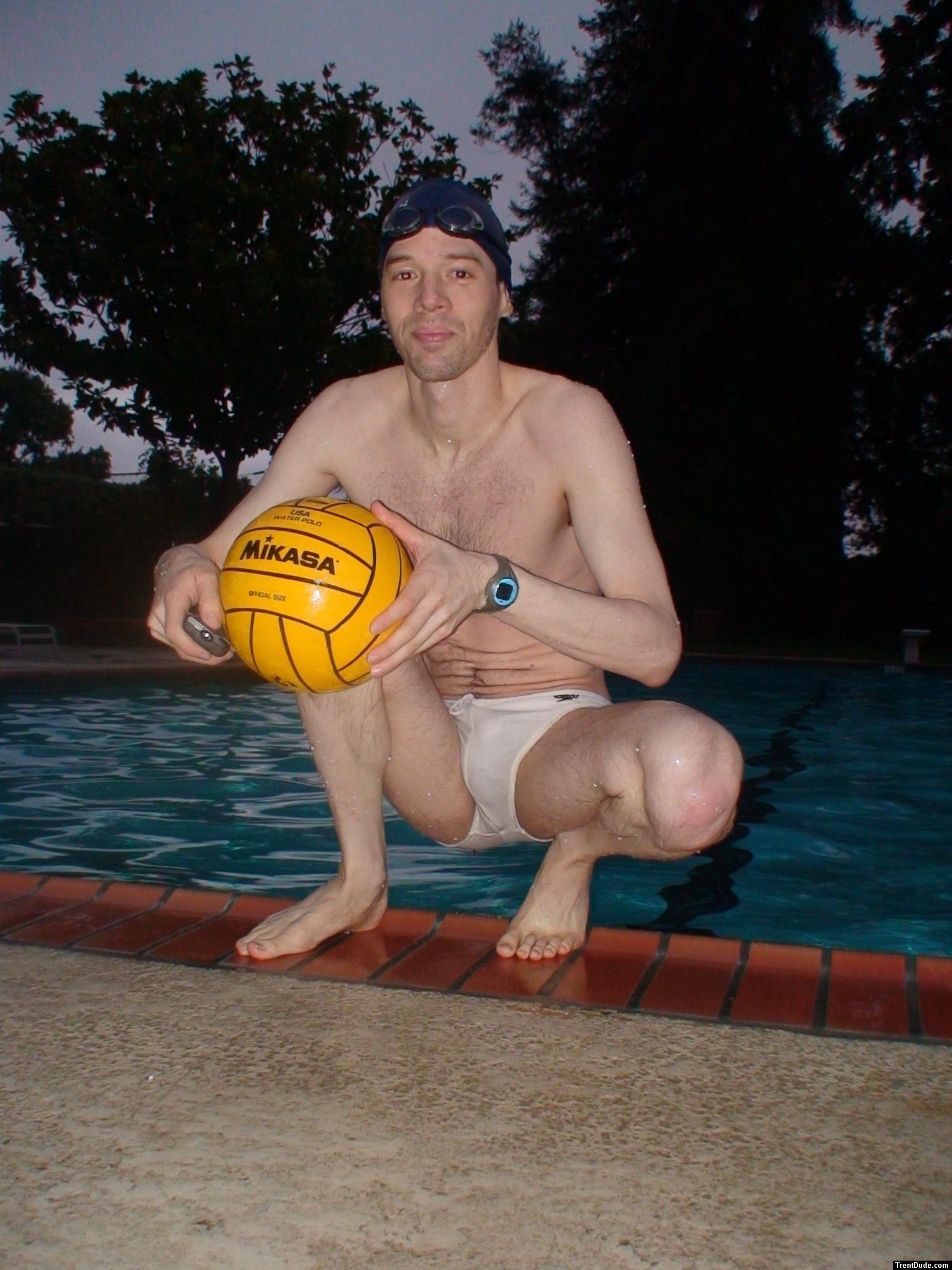 Crouched next to water in a white Speedo (feet)