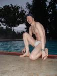 Barefoot swimmer in a white speedo, end of white speedo water polo photoshoot