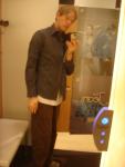 he doesn't have the money to buy them, so instead he models them in the dressing room!
