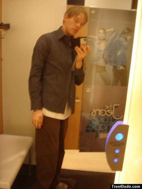 he doesn't have the money to buy them, so instead he models them in the dressing room!