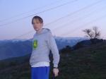 John deere sweatshirt, blue sweat pants, snowy mountain