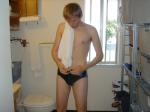 Golden hair swimmer trying to tie the Nike swim suit