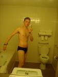 Black speedos, changing in a bathroom