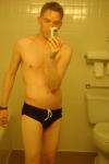 Black speedos, changing in a bathroom