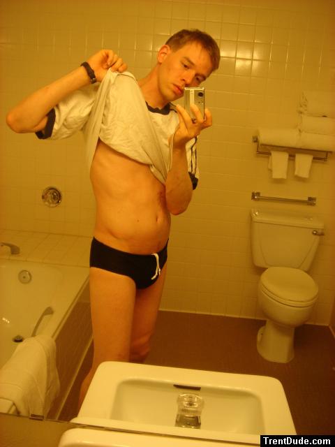 Black speedos, changing in a bathroom